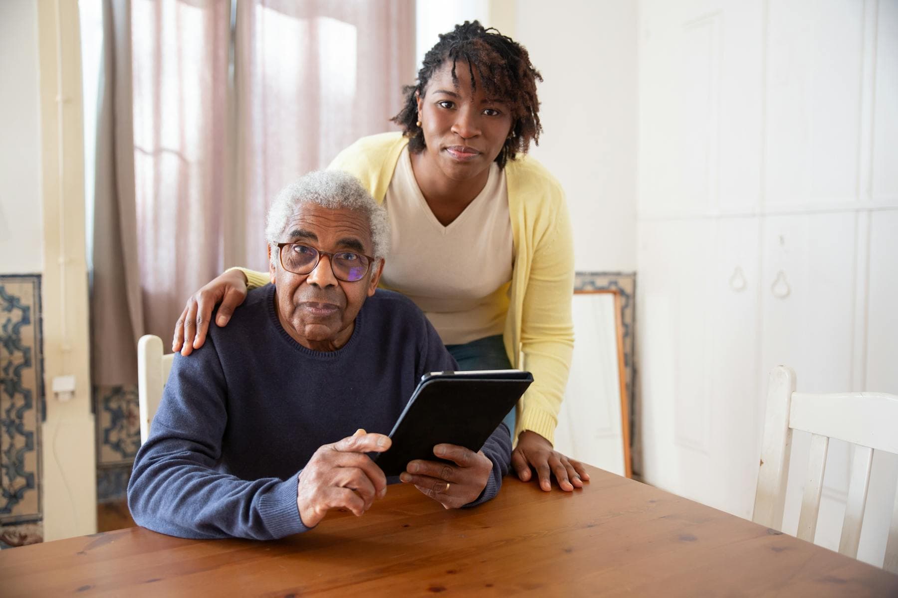 A caregiver supporting an older adult at home